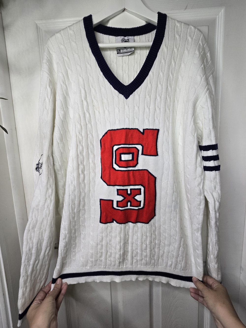 White Cable-Knit V-Neck Sweater with Red Lettering